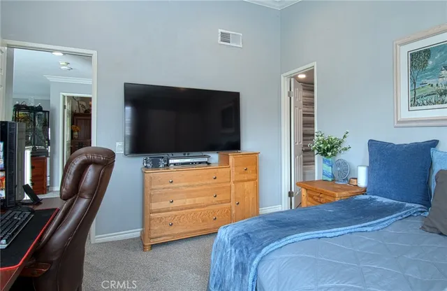 a bedroom with a bed and flat screen tv