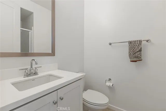 a bathroom with a sink mirror and toilet
