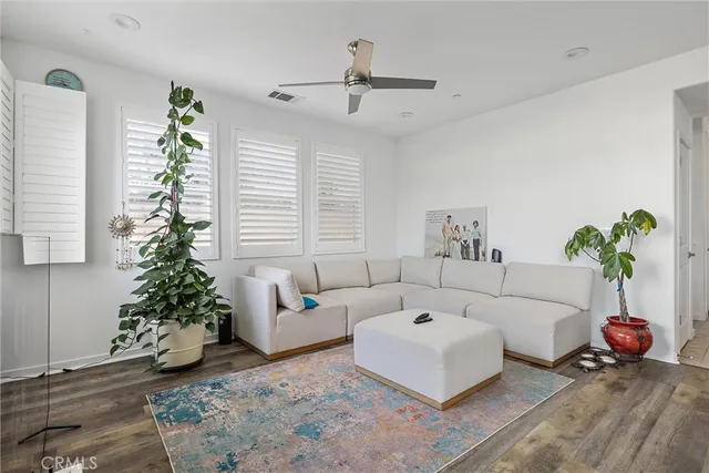 a living room with furniture and a potted plant