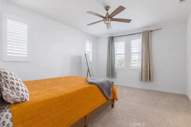 a bedroom with a large bed and a window