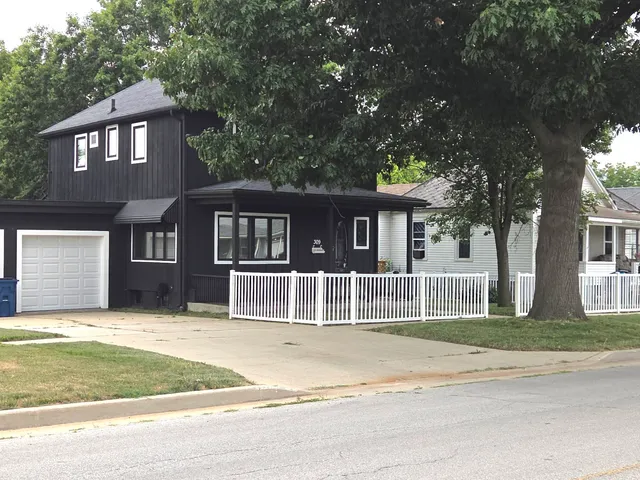 a house that has a tree in front of it
