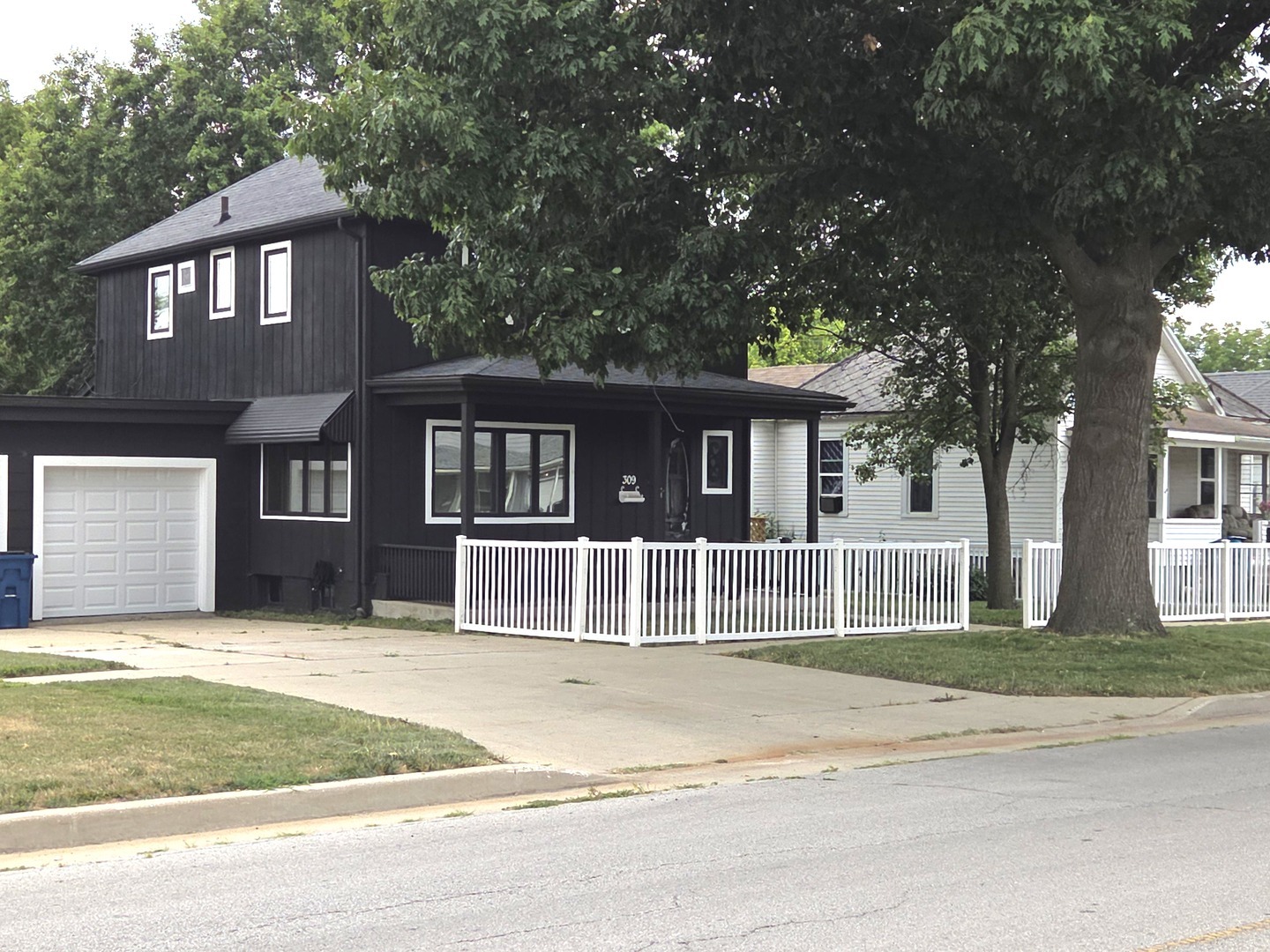 a house that has a tree in front of it