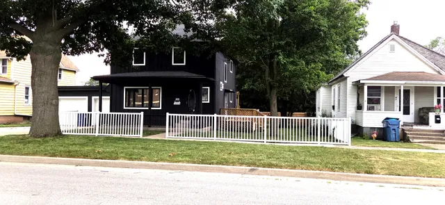 a front view of a house with a garden and yard