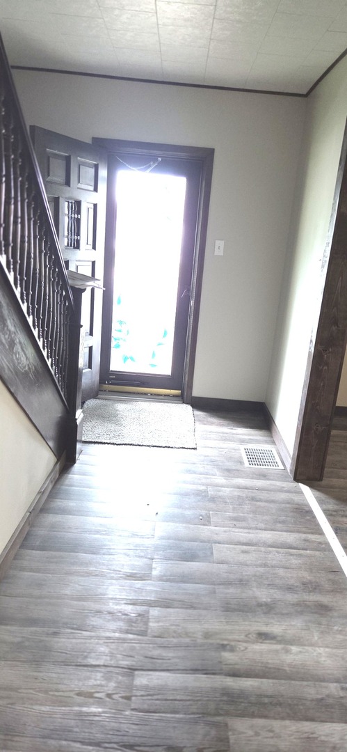 309 North Market Street Hoopeston, IL 60942 - Photo 3 of 45 a view of an empty room with wooden floor and a window