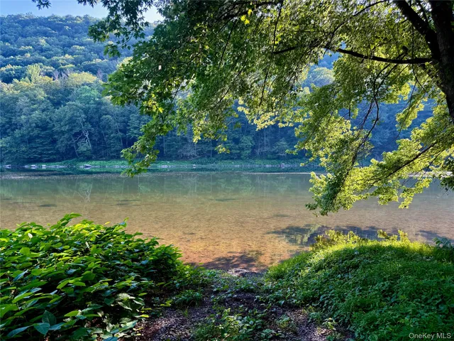 an aerial view of ocean beach and residential houses with outdoor space
