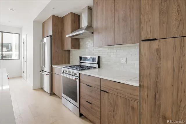 a kitchen with stainless steel appliances a refrigerator and a stove