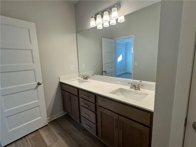 a bathroom with a double vanity sink and a mirror
