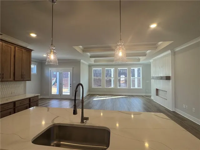 a kitchen with a sink and chandelier