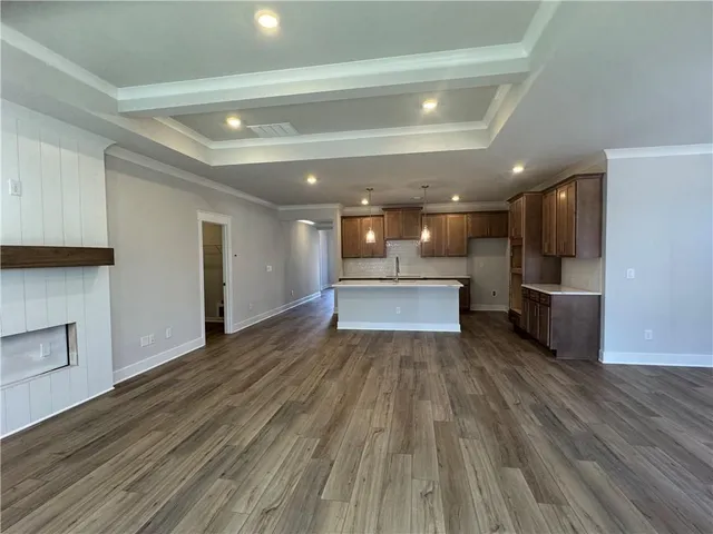 a view of kitchen living room with wooden floor and electronic appliances