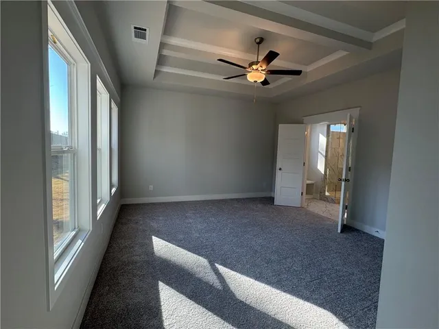 a view of a livingroom with a ceiling fan and window
