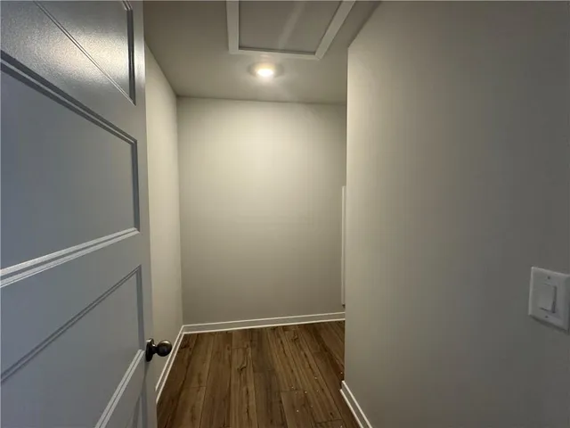 a view of hallway with wooden floor