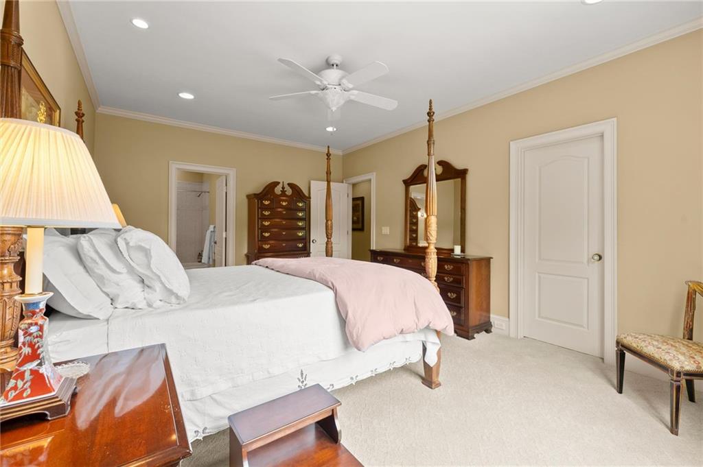322 Edwards Brook Lane Canton, GA 30115 - Photo 56 of 99 a bed room with a bed and a chandelier