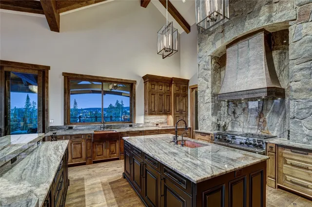 a kitchen with stainless steel appliances granite countertop a stove refrigerator and cabinets