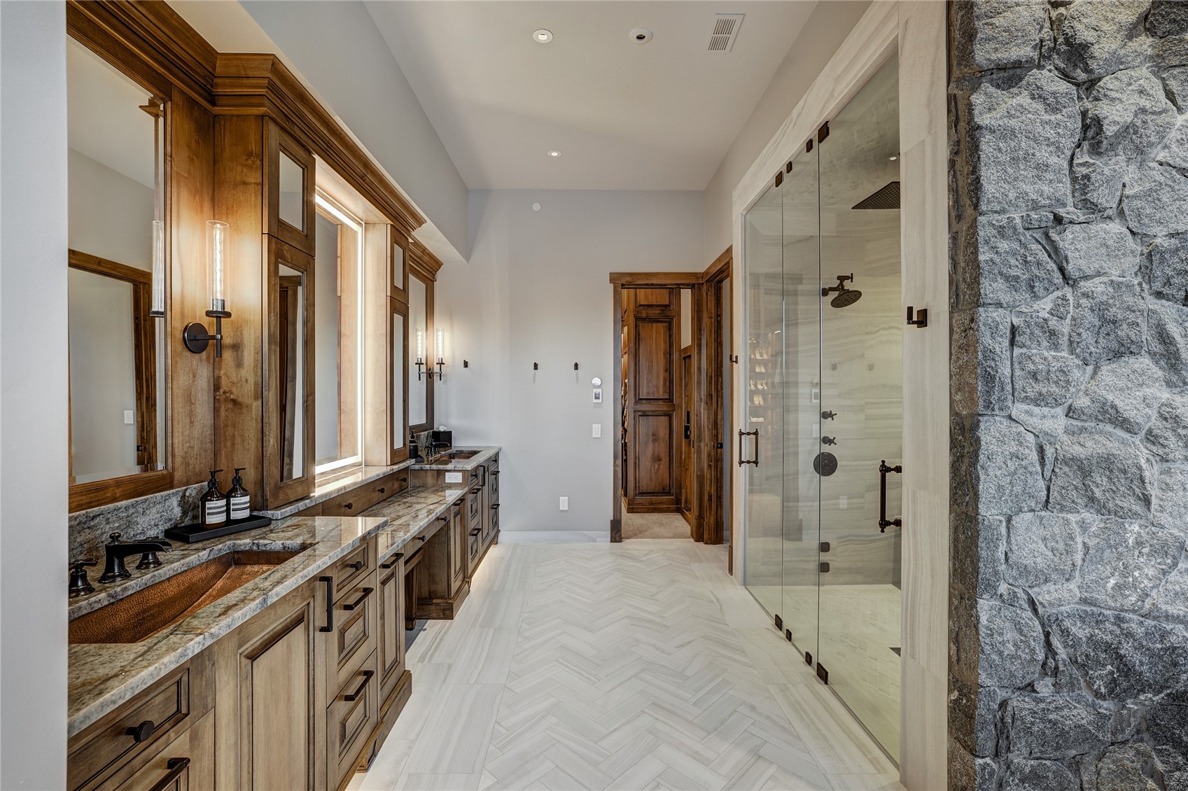 250 Sallie Barber Road Breckenridge, CO 80424 - Photo 27 of 50 a bathroom with a double vanity sink a mirror and a shower