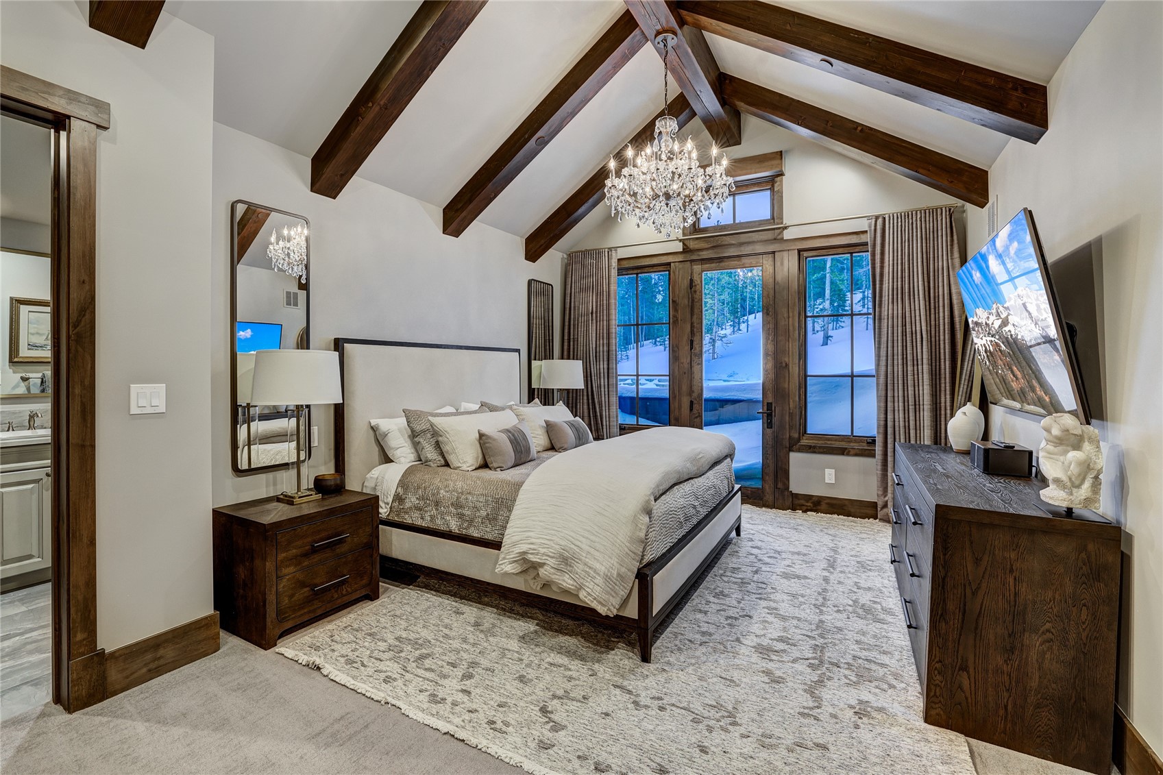 250 Sallie Barber Road Breckenridge, CO 80424 - Photo 29 of 50 a bedroom with a bed a flat tv screen and a dresser