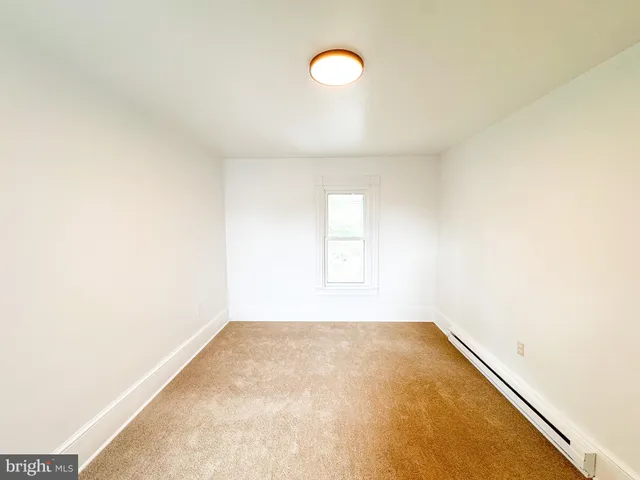a view of a room with window and ceiling fan