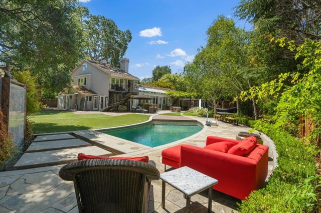 a view of yard with swimming pool and outdoor seating