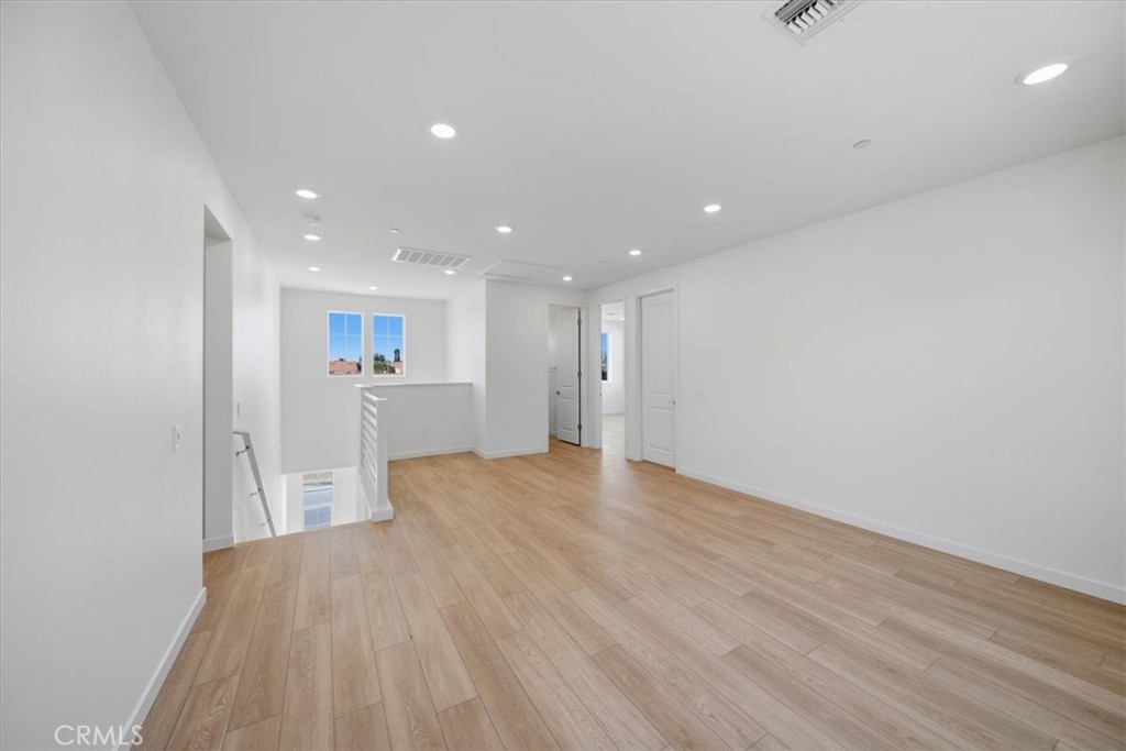 4852 Arroyo Run Moorpark, CA 93021 - Photo 14 of 39 a view of empty room with wooden floor