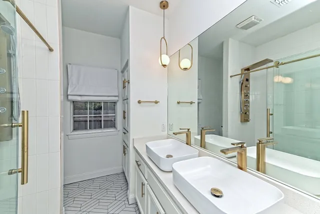 a bathroom with a tub sink and mirror