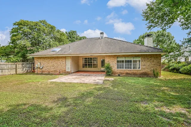 a view of a house with a yard and a garden