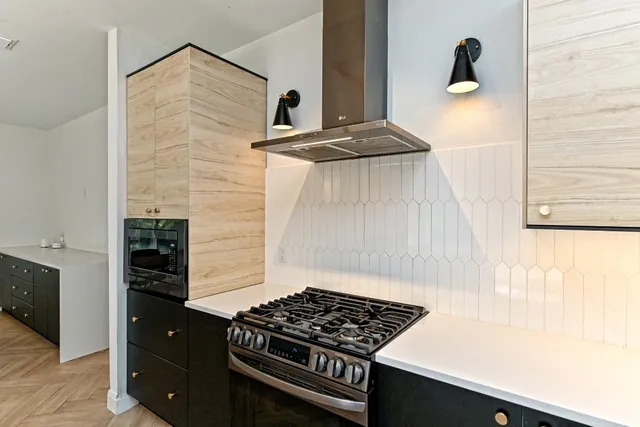 a kitchen with a stove and a shower