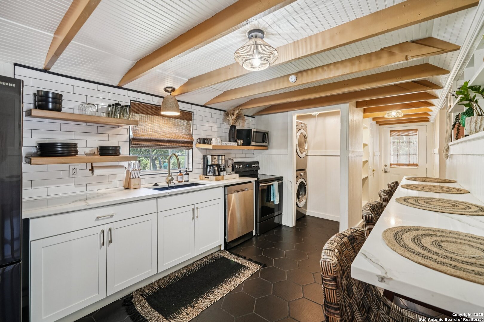 a kitchen with stainless steel appliances granite countertop a sink and cabinets