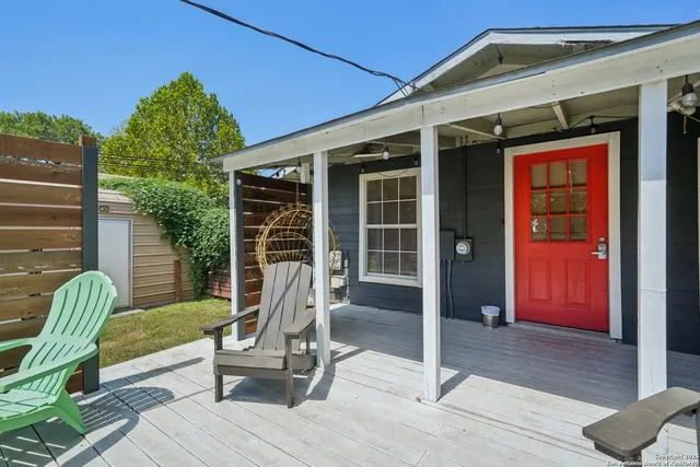a front view of a house with outdoor seating and a garden