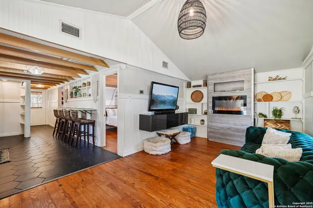 a living room with furniture and wooden floor
