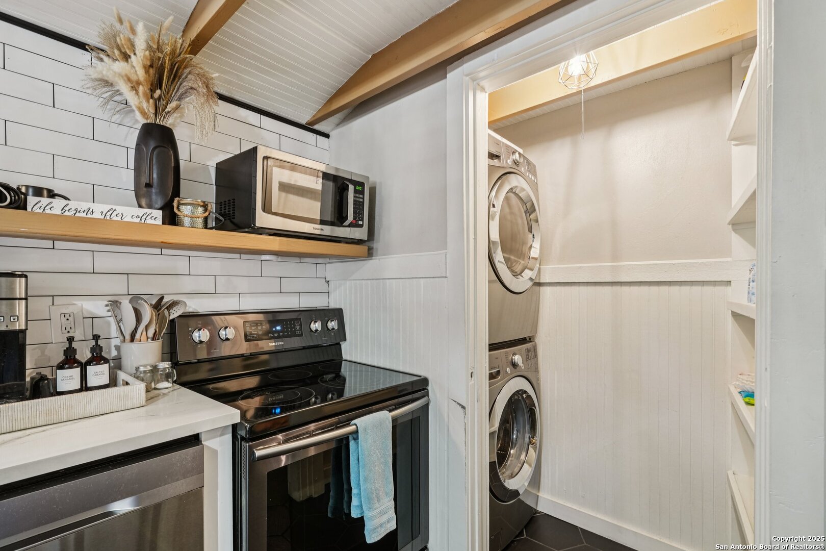 1038 Plateau Ridge New Braunfels, TX 78132 - Photo 9 of 18 a kitchen with a stove and a washing machine with wooden floor