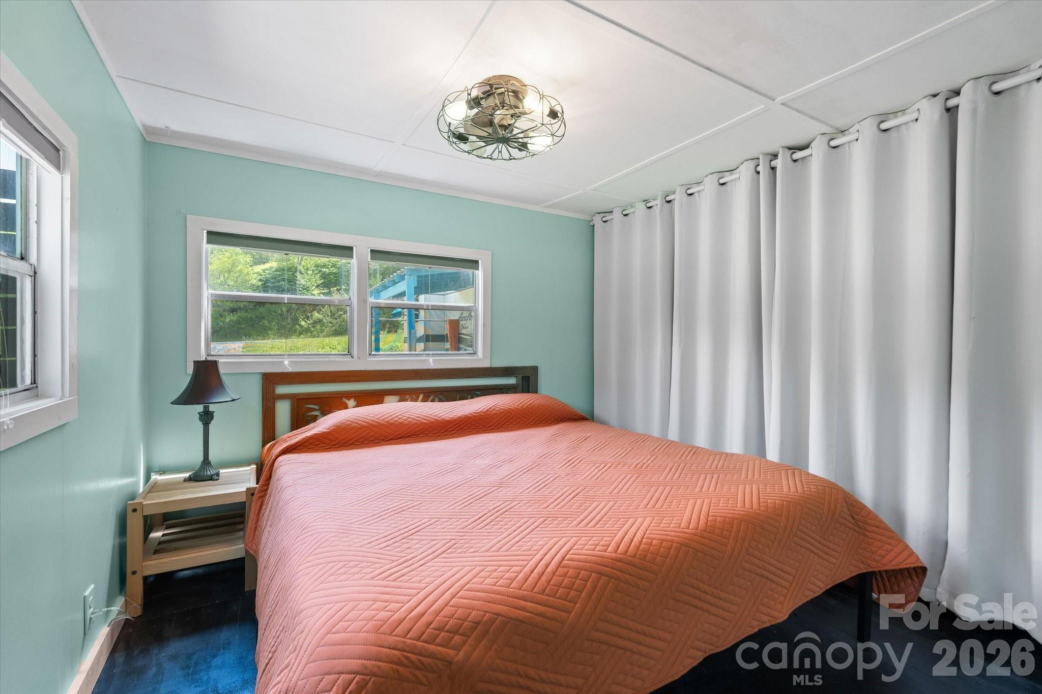72 Amos Creek Road Marshall, NC 28753 - Photo 13 of 28 a bed sitting in a bedroom next to a window