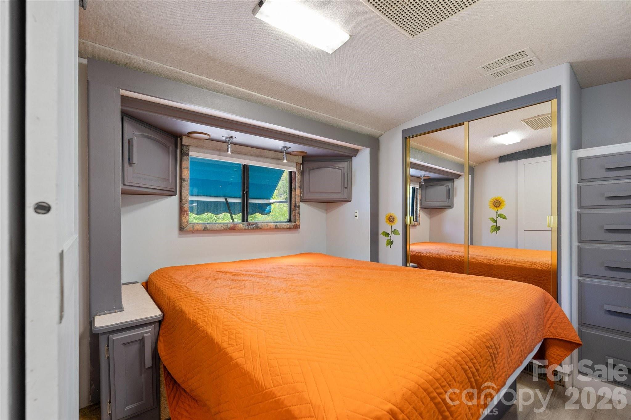 72 Amos Creek Road Marshall, NC 28753 - Photo 22 of 28 a bed sitting in a bedroom next to a window