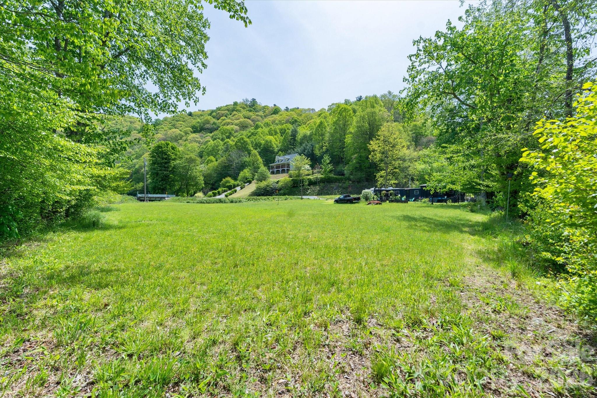 72 Amos Creek Road Marshall, NC 28753 - Photo 27 of 28 a view of a green field with lots of bushes