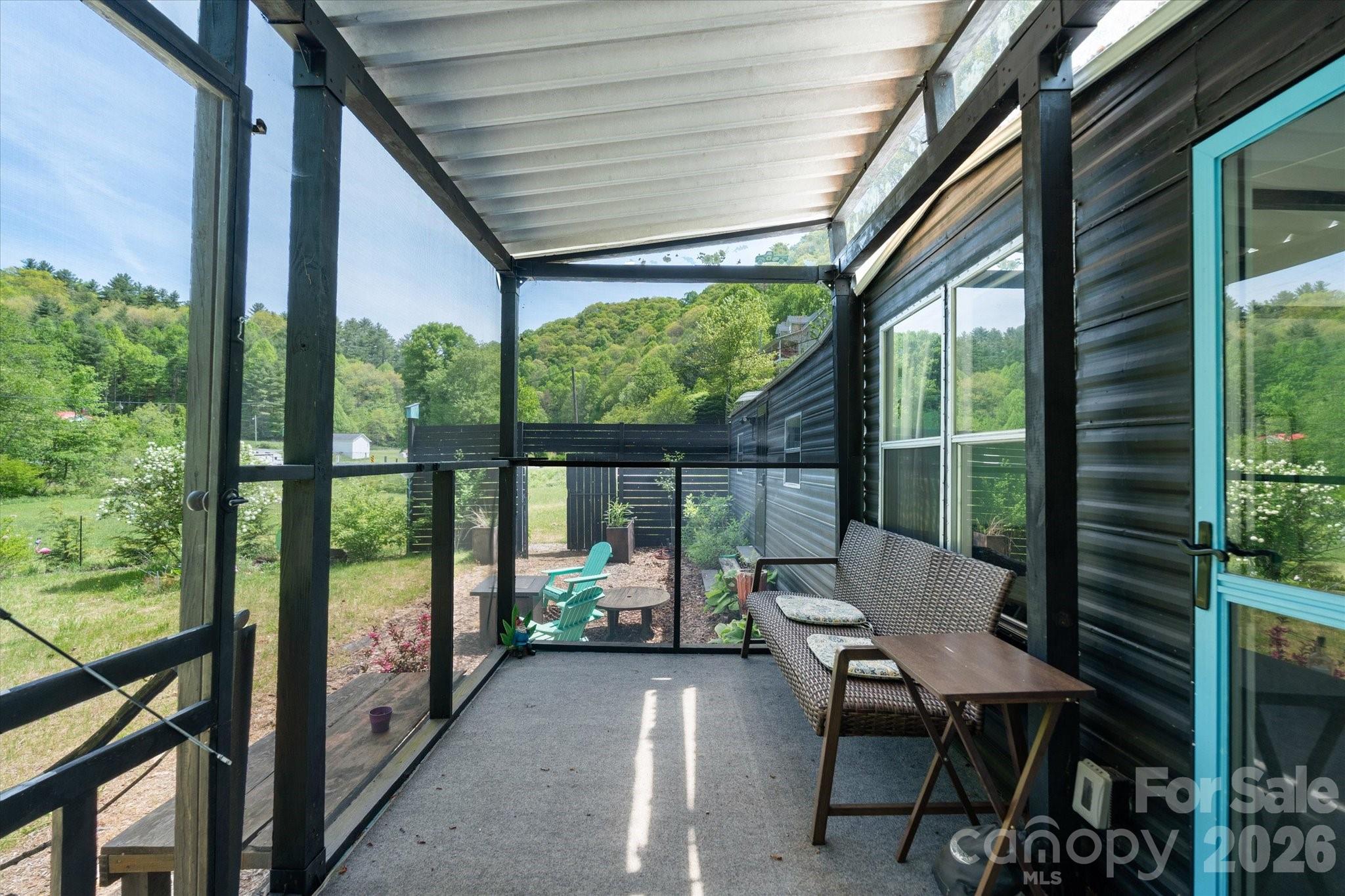72 Amos Creek Road Marshall, NC 28753 - Photo 4 of 28 a balcony with chairs and a table