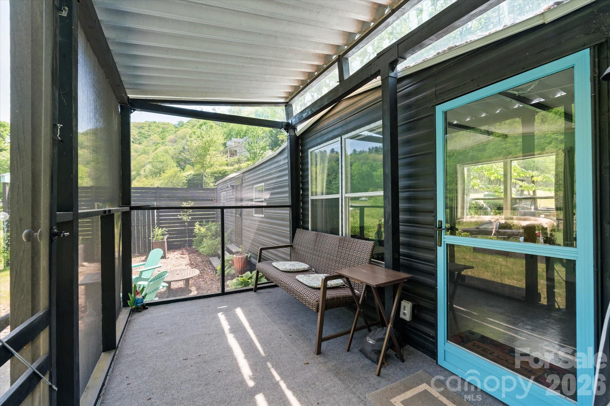 72 Amos Creek Road Marshall, NC 28753 - Photo 5 of 28 a view of a porch with chairs and couches