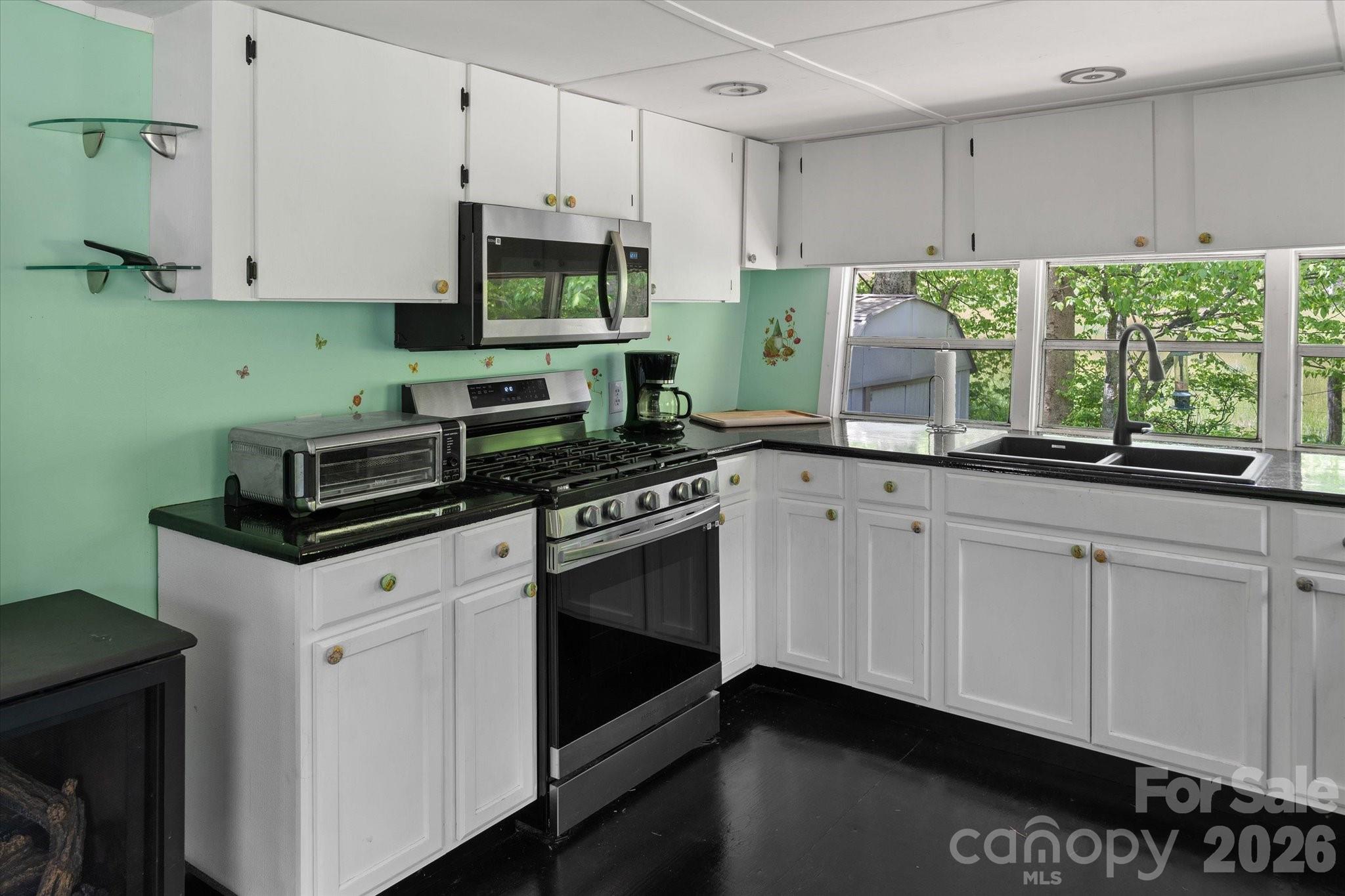 72 Amos Creek Road Marshall, NC 28753 - Photo 8 of 28 a kitchen with granite countertop white cabinets and a stove
