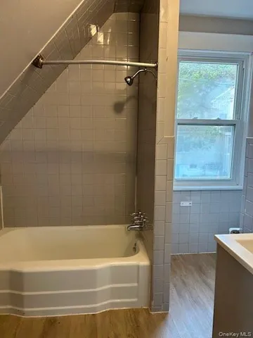 a bathroom with a bathtub and a shower