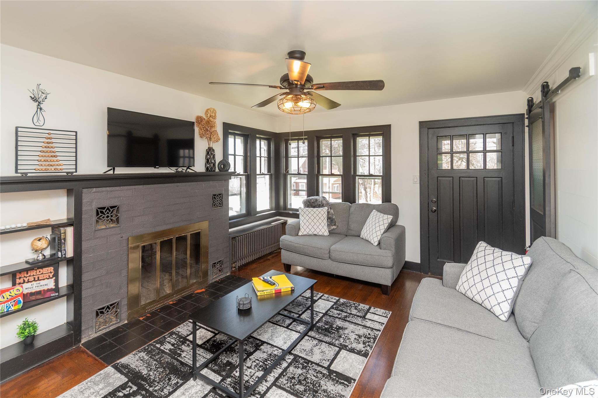 680 Old Rte 17 Livingston Manor, NY 12758 - Photo 11 of 29 a living room with furniture a flat screen tv and a fireplace