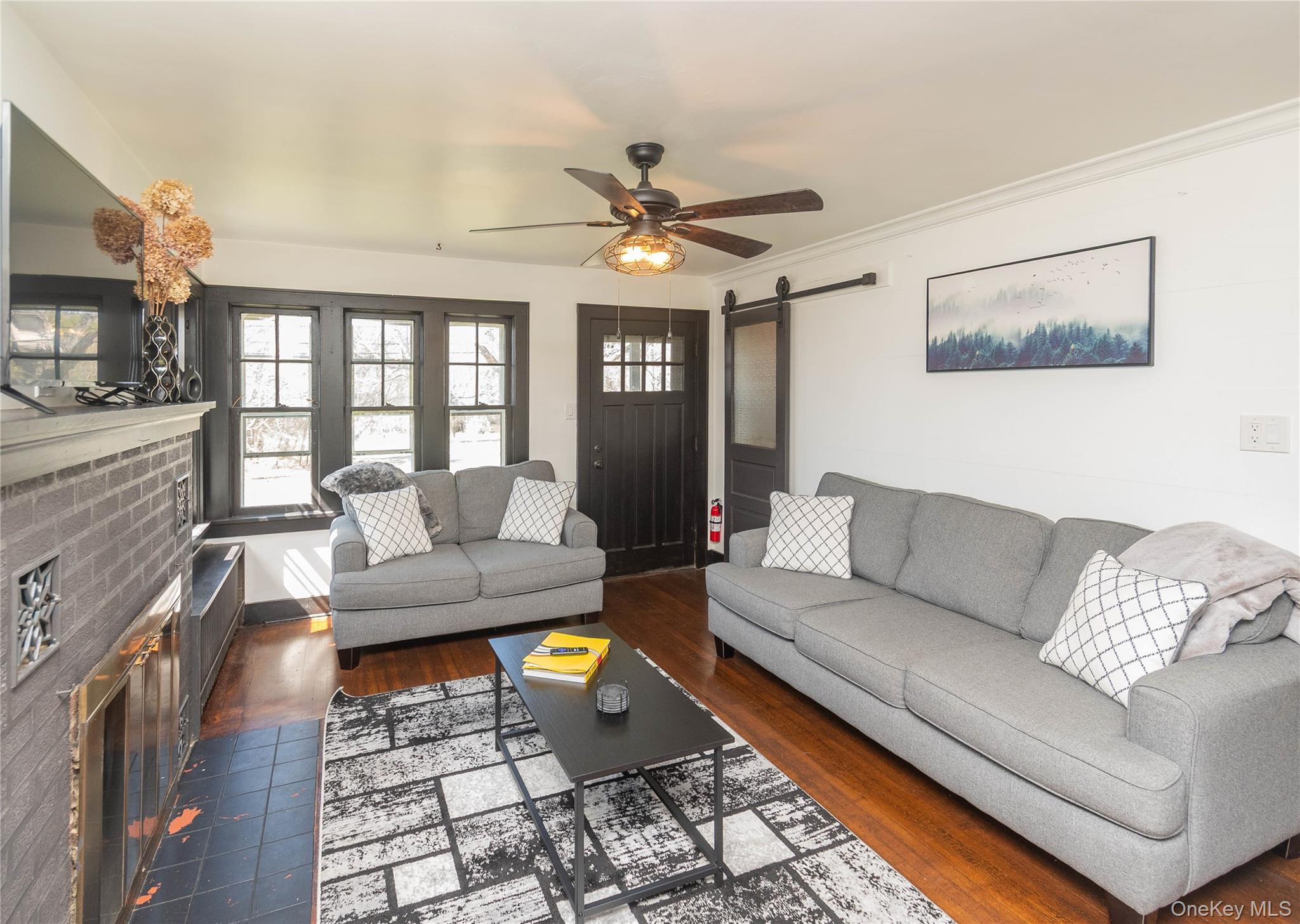 680 Old Rte 17 Livingston Manor, NY 12758 - Photo 12 of 29 a living room with furniture and a chandelier