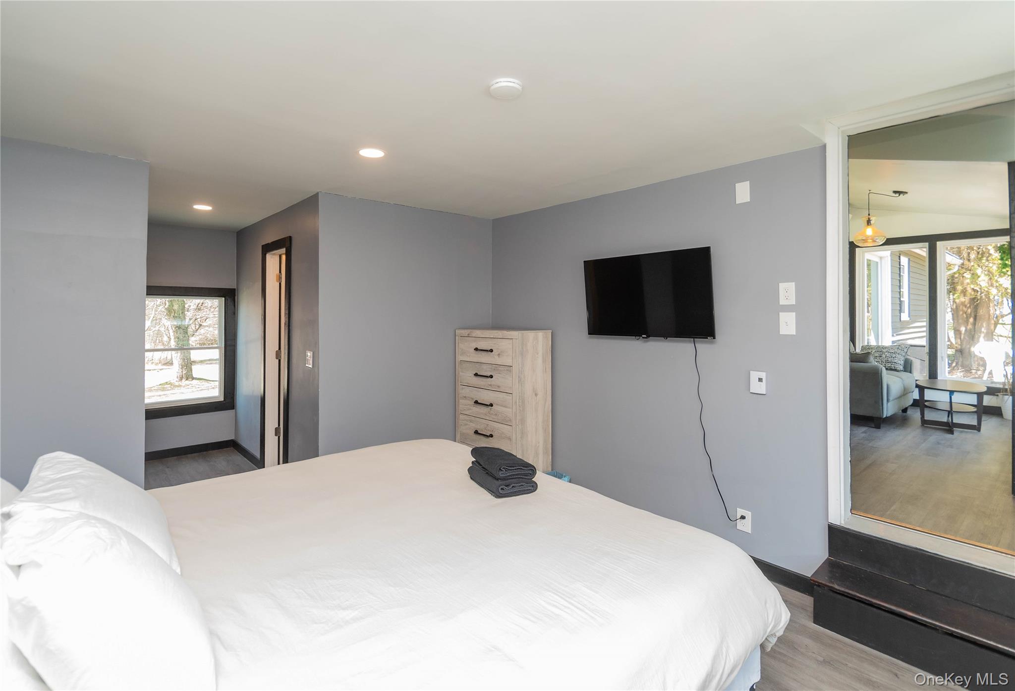 680 Old Rte 17 Livingston Manor, NY 12758 - Photo 19 of 29 a bedroom with a bed and a flat tv screen on wall