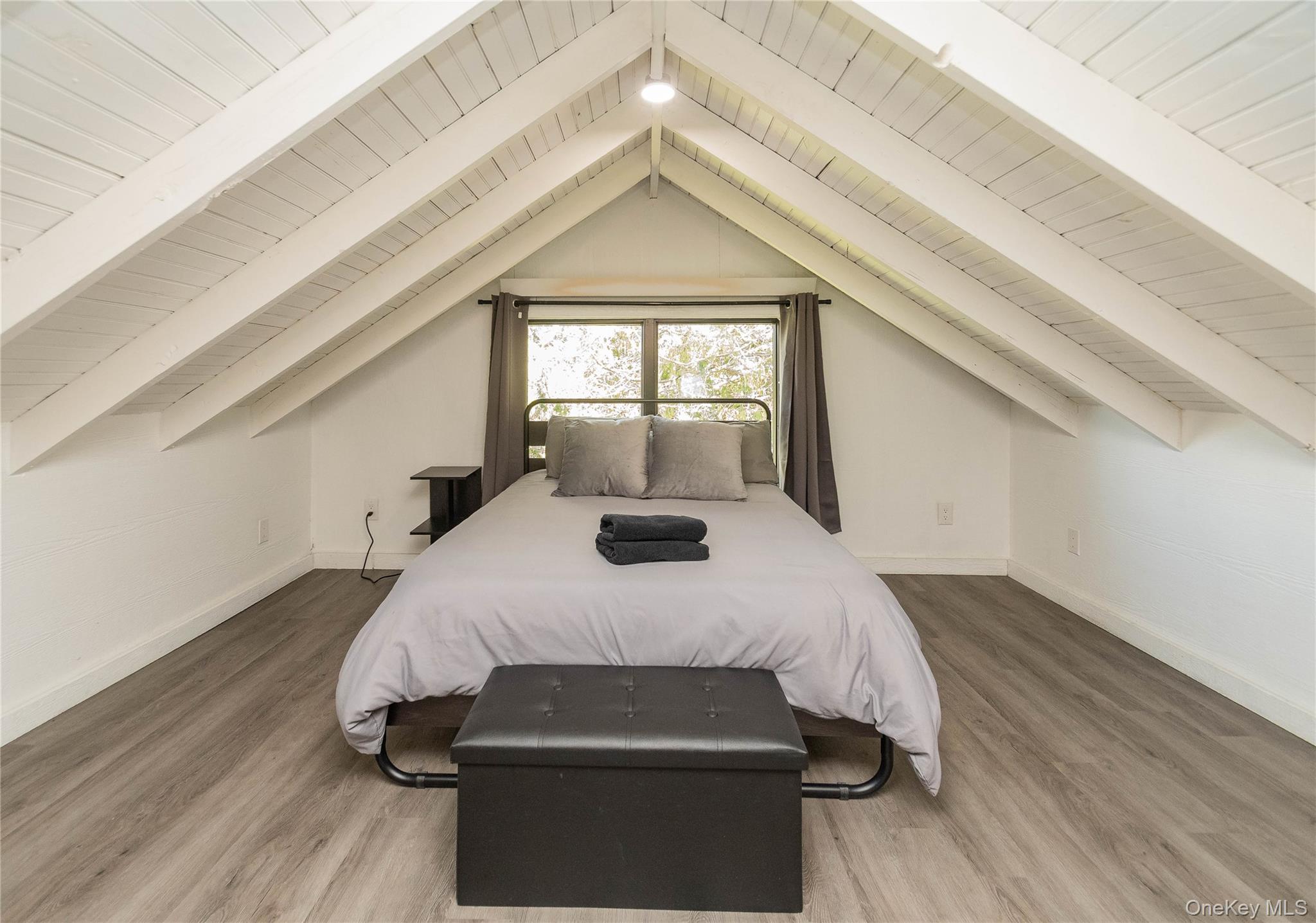 680 Old Rte 17 Livingston Manor, NY 12758 - Photo 22 of 29 a bedroom with a bed and wooden floor