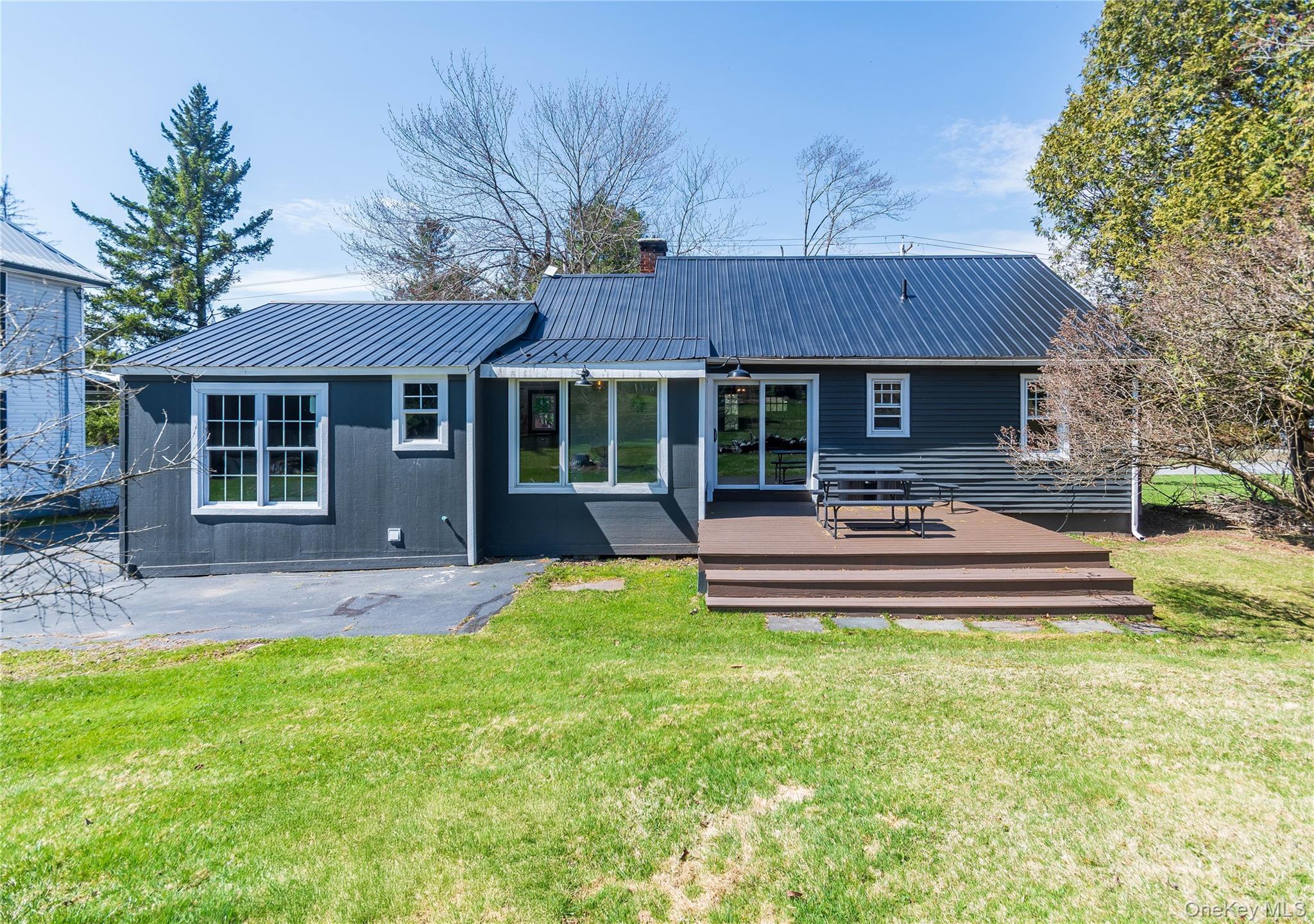680 Old Rte 17 Livingston Manor, NY 12758 - Photo 27 of 29 a front view of a house with a yard table and chairs