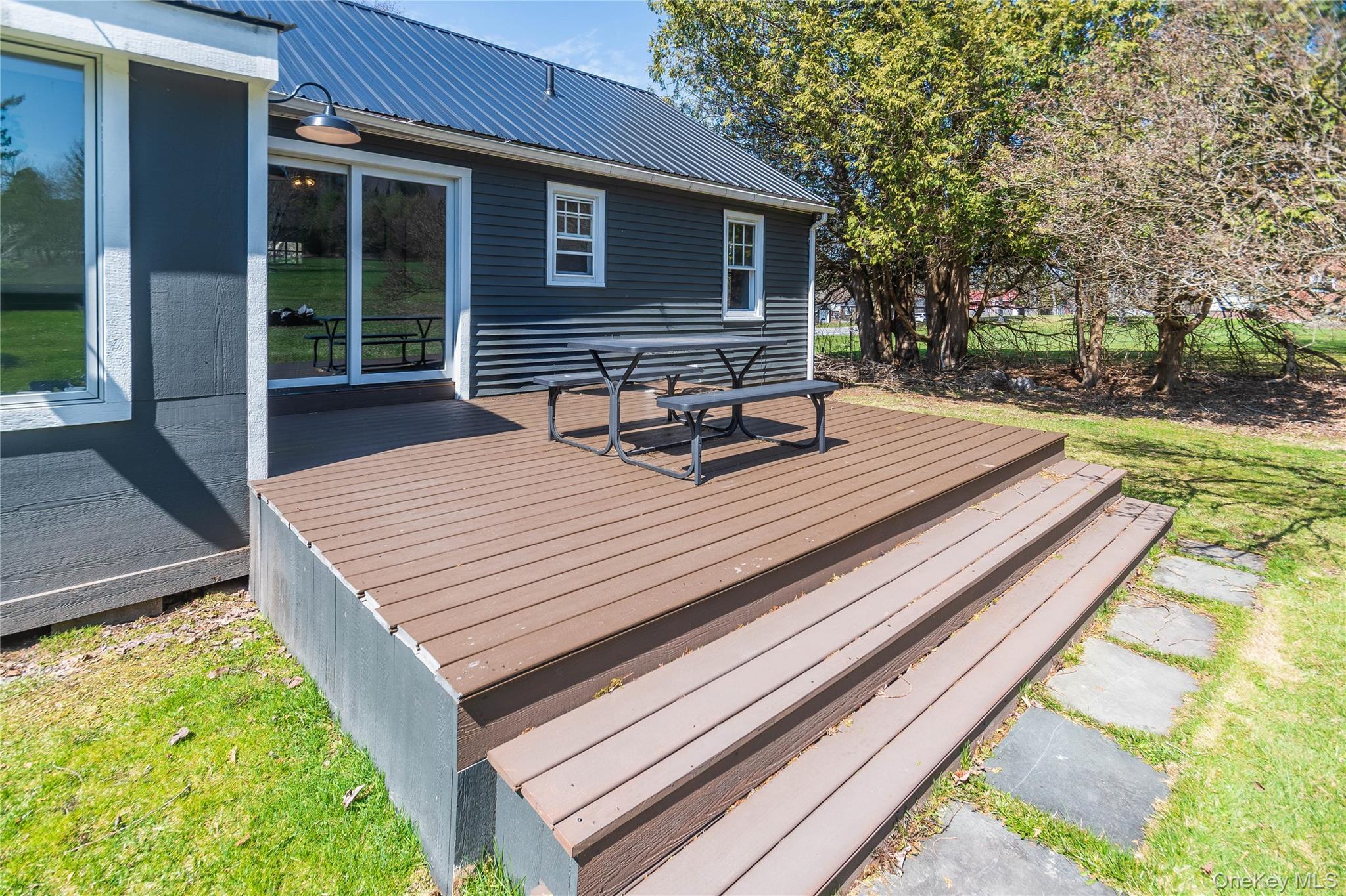 680 Old Rte 17 Livingston Manor, NY 12758 - Photo 28 of 29 a view of a patio with table and chairs with wooden floor and fence