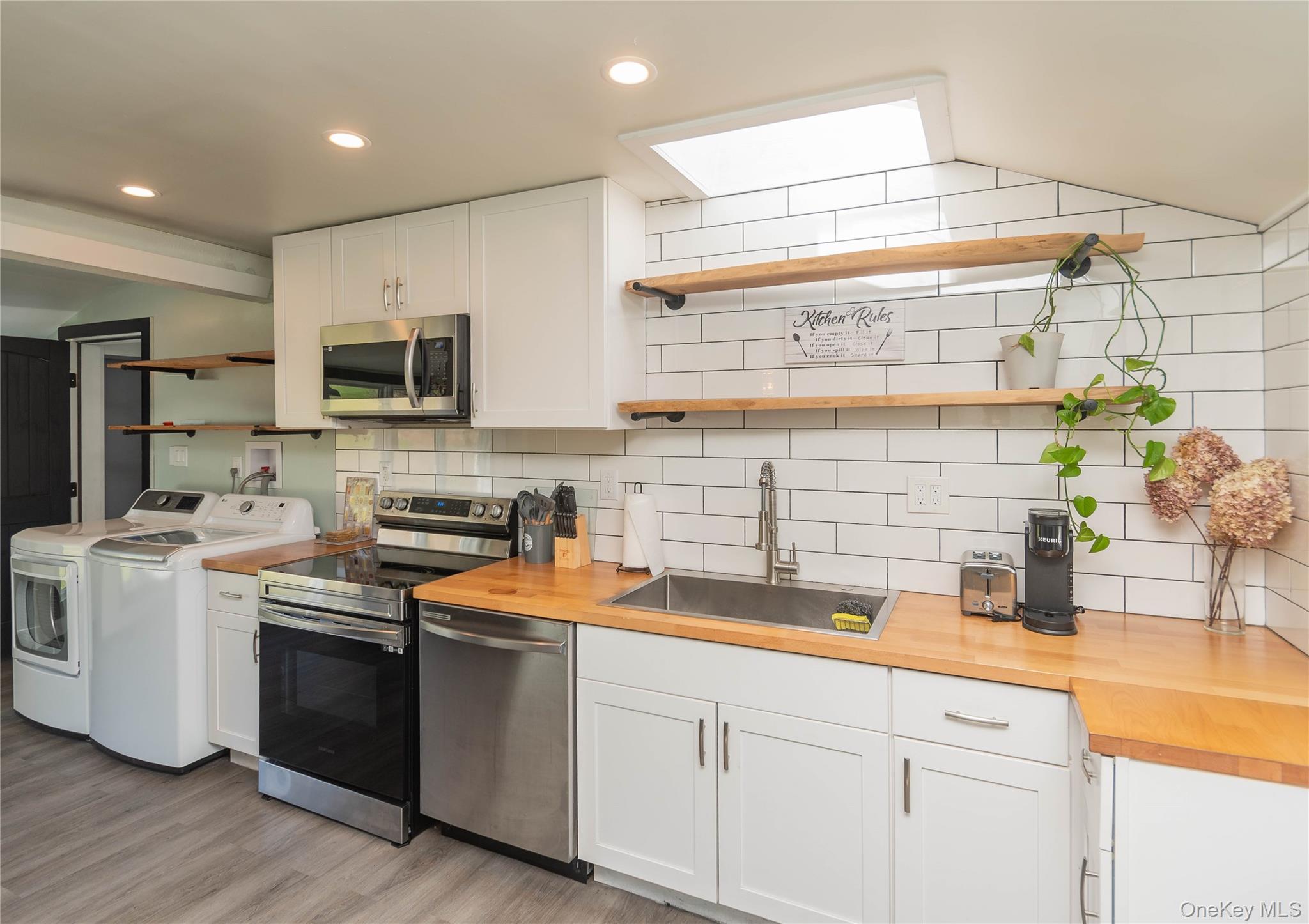 680 Old Rte 17 Livingston Manor, NY 12758 - Photo 3 of 29 a kitchen with stainless steel appliances a sink dishwasher a stove a microwave a refrigerator and cabinets