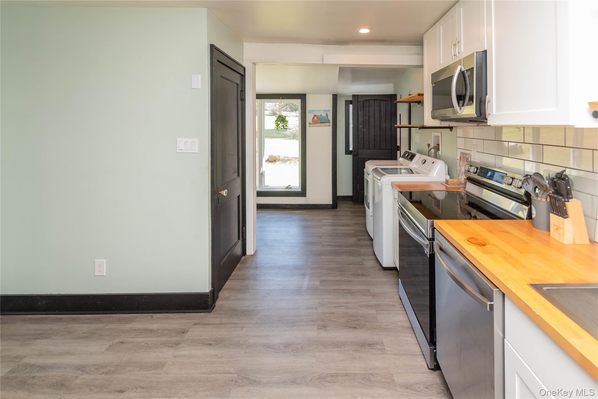 680 Old Rte 17 Livingston Manor, NY 12758 - Photo 4 of 29 a kitchen with stainless steel appliances granite countertop a sink and wooden cabinets
