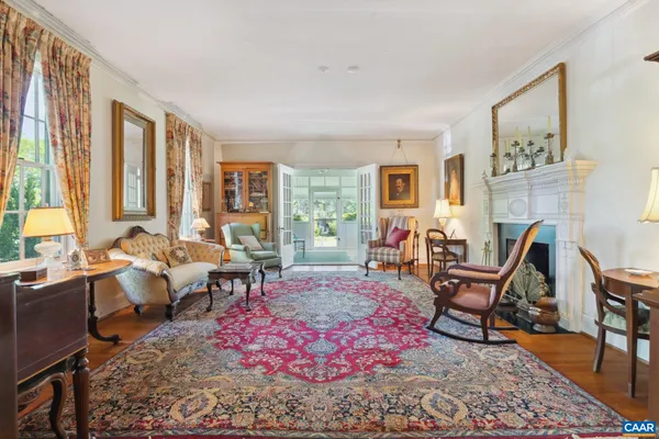 a living room with furniture a rug and a window