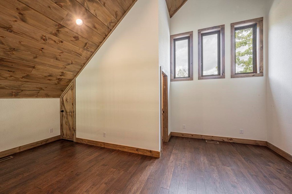 86 Valley Lake Road Mineral Bluff, GA 30559 - Photo 31 of 59 an empty room with wooden floor and windows