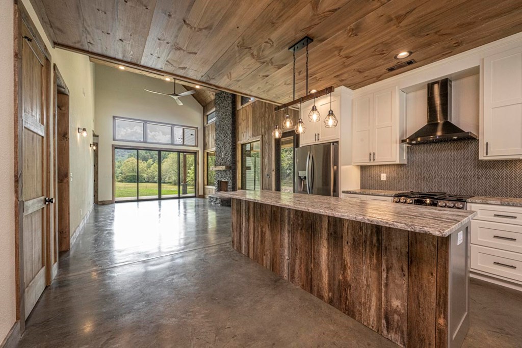 86 Valley Lake Road Mineral Bluff, GA 30559 - Photo 5 of 59 a kitchen with stainless steel appliances granite countertop a stove a sink and a refrigerator