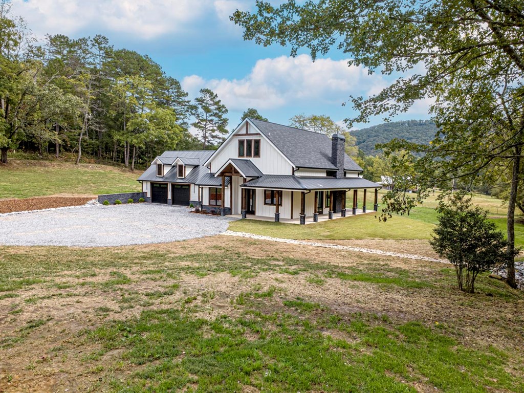 86 Valley Lake Road Mineral Bluff, GA 30559 - Photo 52 of 59 a front view of a house with a garden