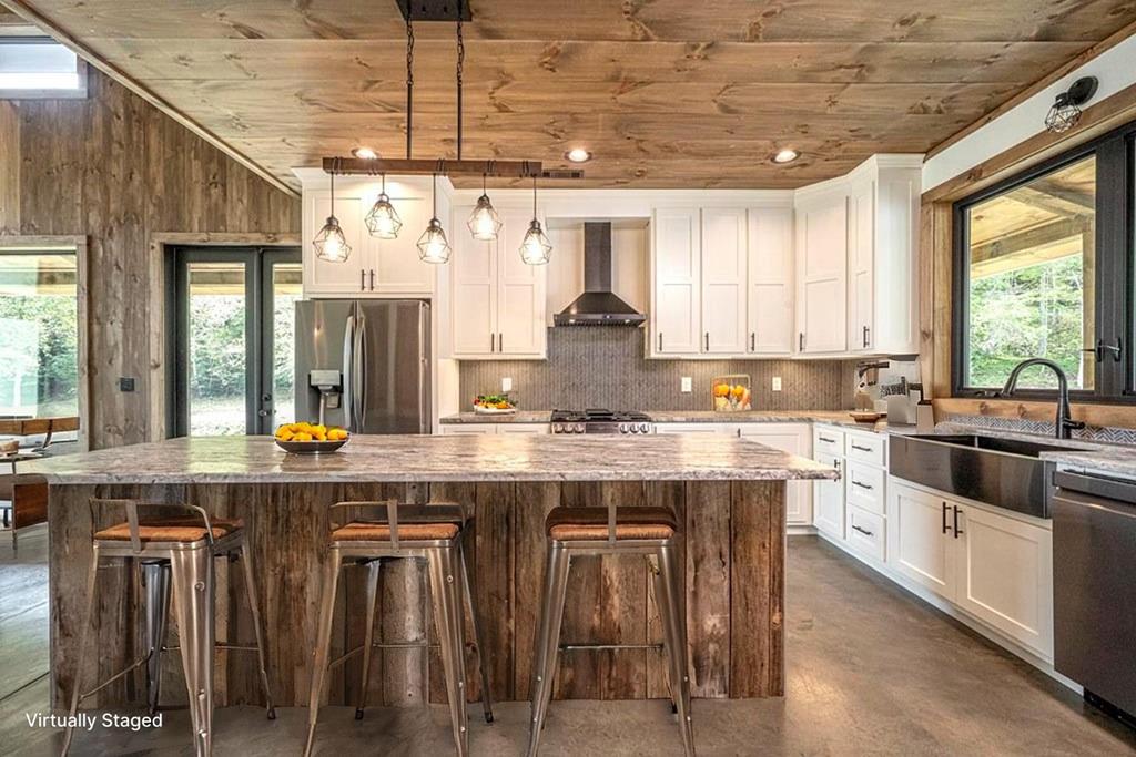86 Valley Lake Road Mineral Bluff, GA 30559 - Photo 57 of 59 a kitchen with stainless steel appliances granite countertop wooden cabinets a stove top oven a sink and dishwasher