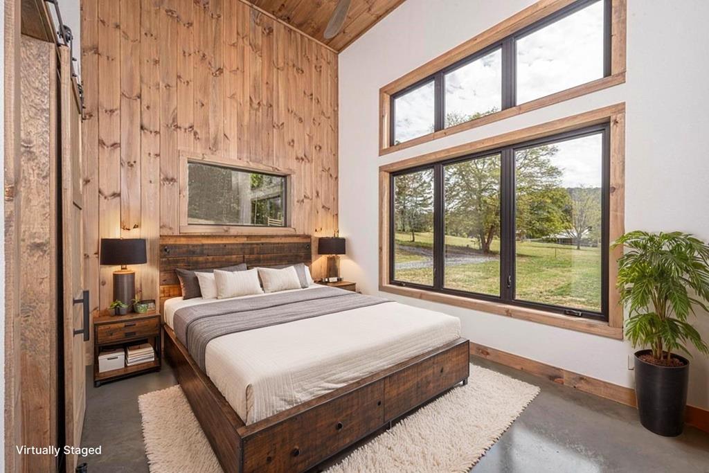 86 Valley Lake Road Mineral Bluff, GA 30559 - Photo 58 of 59 a bedroom with a large bed and a large window